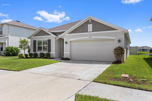 33369 Hamilton Hill Ln, Wesley Chapel, FL 33545 - ranch-style house featuring a front yard, a garage, driveway, and stucco siding