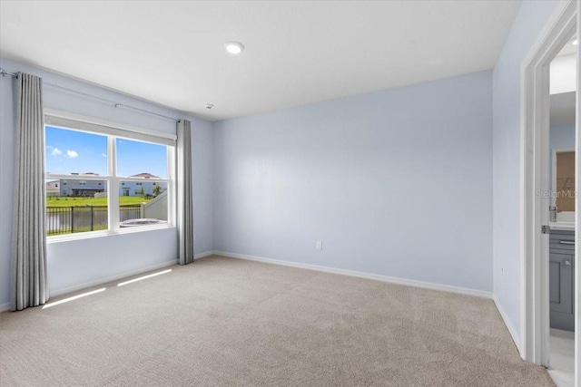33369 Hamilton Hill Ln, Wesley Chapel, FL 33545 - spare room featuring light colored carpet and baseboards