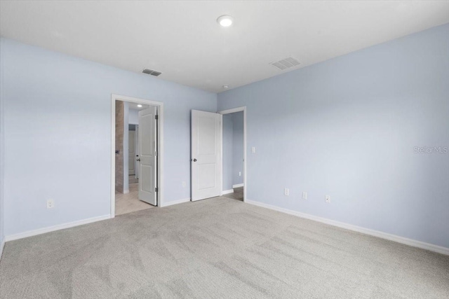 33369 Hamilton Hill Ln, Wesley Chapel, FL 33545 - unfurnished bedroom with carpet floors, ensuite bathroom, and recessed lighting