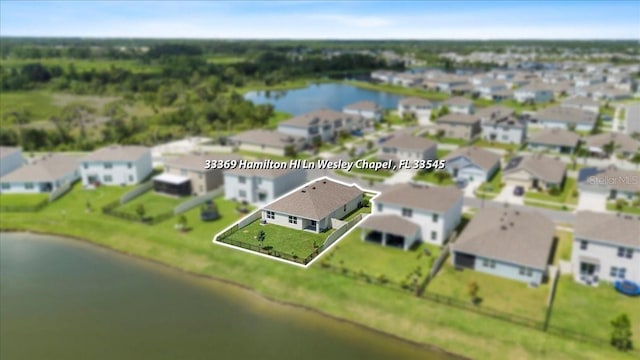 33369 Hamilton Hill Ln, Wesley Chapel, FL 33545 - aerial view of residential area featuring a nearby body of water and property parcel outlined