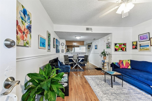 3335 Fox Hunt Dr, Palm Harbor, FL 34683 - living room with a textured ceiling, wood finished floors, and ceiling fan