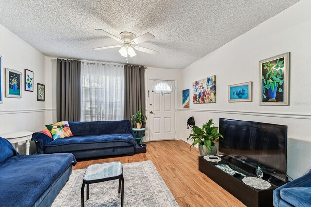 3335 Fox Hunt Dr, Palm Harbor, FL 34683 - living room with a ceiling fan, wood finished floors, and a textured ceiling