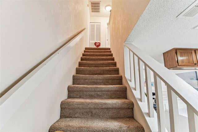 3335 Fox Hunt Dr, Palm Harbor, FL 34683 - stairs featuring a textured ceiling