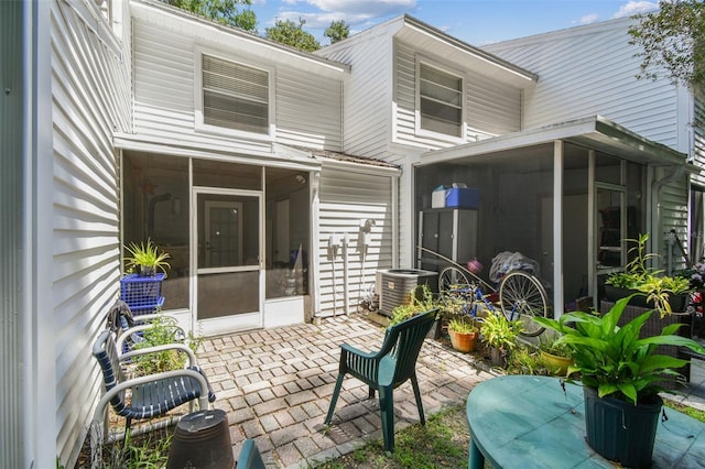 3335 Fox Hunt Dr, Palm Harbor, FL 34683 - rear view of house featuring a sunroom and a patio area