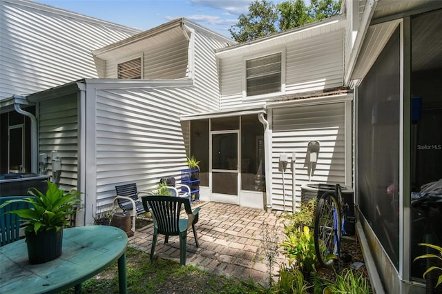 3335 Fox Hunt Dr, Palm Harbor, FL 34683 - back of house featuring a sunroom and a patio area