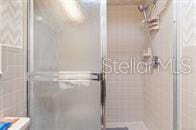 5781 S Utopia Ter, Inverness, FL 34452 - full bath with a stall shower and tile walls