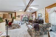 5781 S Utopia Ter, Inverness, FL 34452 - living room featuring ceiling fan and beam ceiling