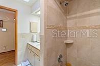 5781 S Utopia Ter, Inverness, FL 34452 - bathroom featuring vanity, a wainscoted wall, and a shower