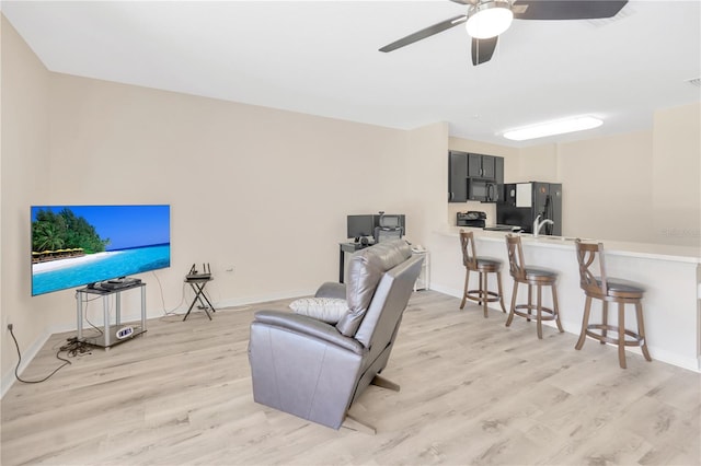 12710 Buffalo Run Dr, Gibsonton, FL 33534 - living room with light wood-style floors and a ceiling fan