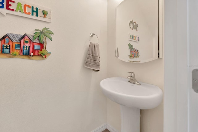 12710 Buffalo Run Dr, Gibsonton, FL 33534 - bathroom featuring baseboards and a sink