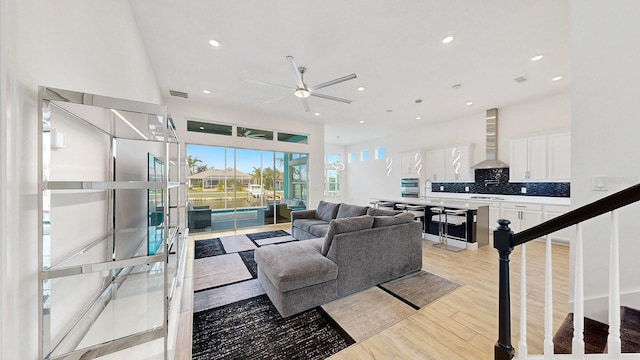 5307 Wishing Arch Dr, Apollo Beach, FL 33572 - living room with ceiling fan, light wood finished floors, and recessed lighting