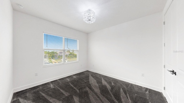 5307 Wishing Arch Dr, Apollo Beach, FL 33572 - empty room with dark colored carpet, a smoke detector, and a chandelier