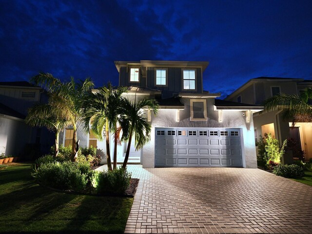 5307 Wishing Arch Dr, Apollo Beach, FL 33572 - view of front of house featuring decorative driveway, a garage, and stucco siding