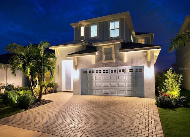 5307 Wishing Arch Dr, Apollo Beach, FL 33572 - view of front of property with decorative driveway, stucco siding, and an attached garage