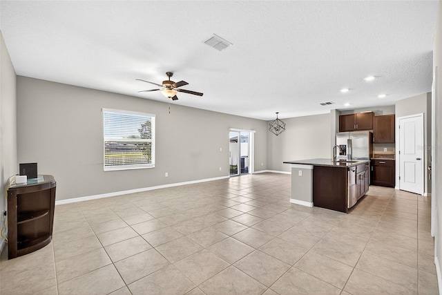 13324 Willow Bluestar Loop, Riverview, FL 33579 - kitchen featuring open floor plan, stainless steel fridge with ice dispenser, light tile patterned floors, a ceiling fan, and a kitchen island with sink