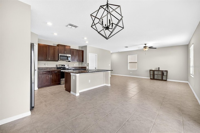 13324 Willow Bluestar Loop, Riverview, FL 33579 - kitchen featuring appliances with stainless steel finishes, light tile patterned floors, open floor plan, dark brown cabinets, and recessed lighting