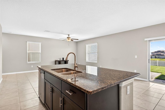13324 Willow Bluestar Loop, Riverview, FL 33579 - kitchen with dishwasher, light tile patterned floors, a ceiling fan, dark stone countertops, and dark brown cabinets