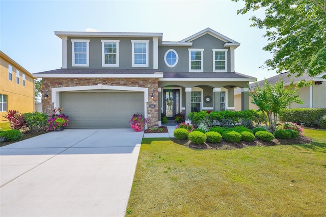 11044 Spring Point Cir, Riverview, FL 33579 - view of front of home featuring a front lawn, stone siding, concrete driveway, stucco siding, and a garage