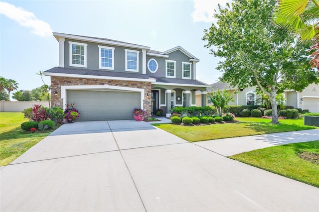11044 Spring Point Cir, Riverview, FL 33579 - view of front of property featuring stucco siding, stone siding, a garage, concrete driveway, and a front lawn