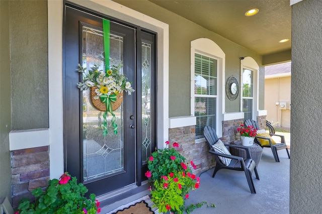 11044 Spring Point Cir, Riverview, FL 33579 - property entrance featuring a porch, stone siding, and stucco siding