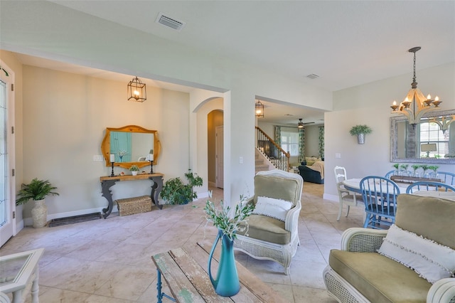 11044 Spring Point Cir, Riverview, FL 33579 - living area featuring a chandelier, stairs, arched walkways, and healthy amount of natural light