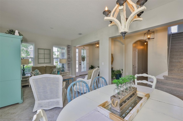 11044 Spring Point Cir, Riverview, FL 33579 - dining room with stairway, arched walkways, and tile patterned floors