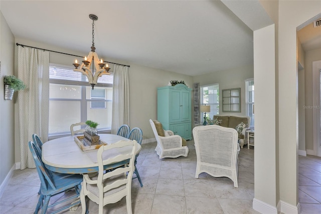 11044 Spring Point Cir, Riverview, FL 33579 - dining space featuring a chandelier and light tile patterned flooring