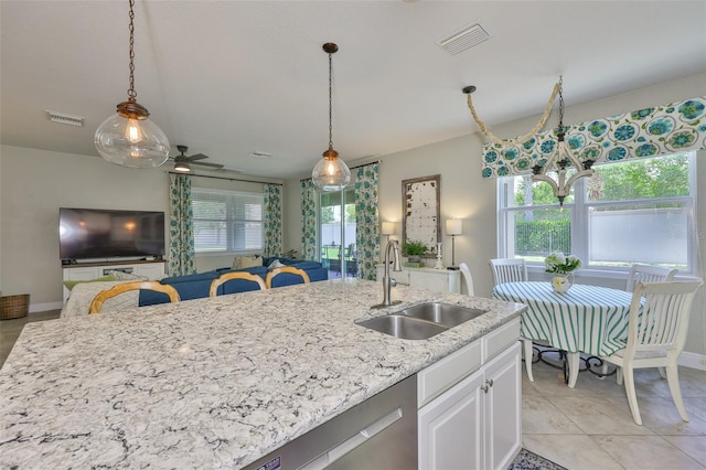 11044 Spring Point Cir, Riverview, FL 33579 - kitchen featuring healthy amount of natural light, hanging light fixtures, and white cabinetry
