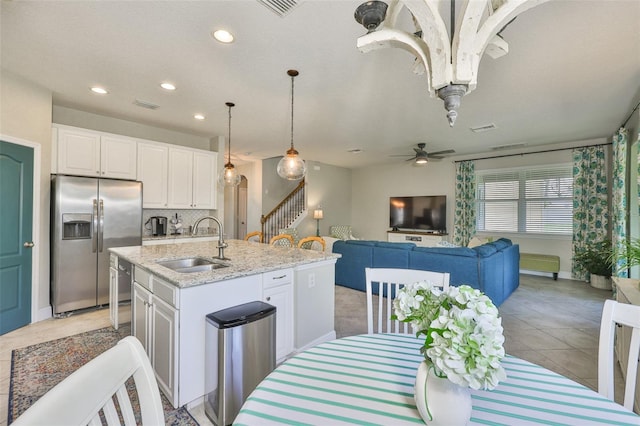 11044 Spring Point Cir, Riverview, FL 33579 - kitchen with stainless steel appliances, white cabinets, recessed lighting, light stone counters, and a ceiling fan