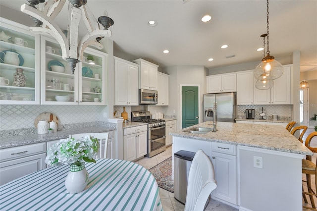 11044 Spring Point Cir, Riverview, FL 33579 - kitchen featuring appliances with stainless steel finishes, decorative backsplash, white cabinets, recessed lighting, and glass insert cabinets