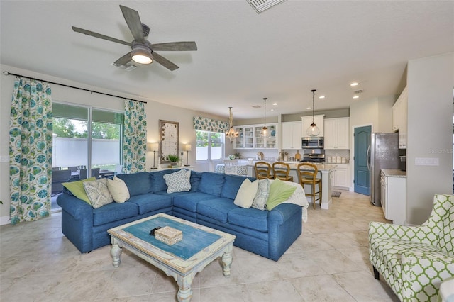 11044 Spring Point Cir, Riverview, FL 33579 - living area with a ceiling fan and light tile patterned flooring