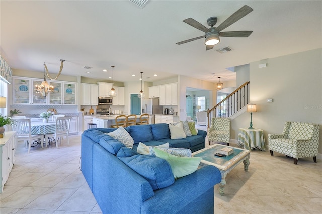 11044 Spring Point Cir, Riverview, FL 33579 - living area featuring a chandelier, light tile patterned floors, ceiling fan, and stairs