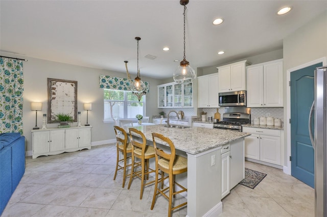 11044 Spring Point Cir, Riverview, FL 33579 - kitchen featuring appliances with stainless steel finishes, white cabinetry, backsplash, light stone counters, and recessed lighting