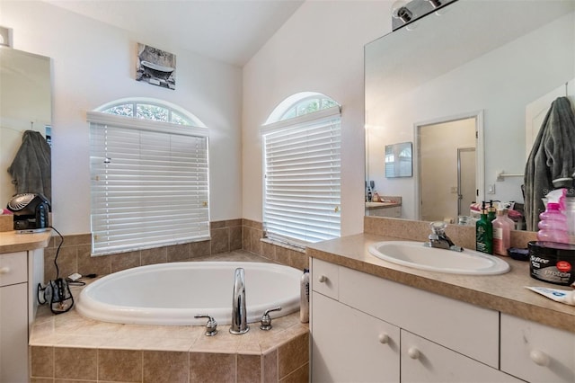 7046 Frascati Loop, Wesley Chapel, FL 33544 - bathroom with vanity, a bath, and lofted ceiling