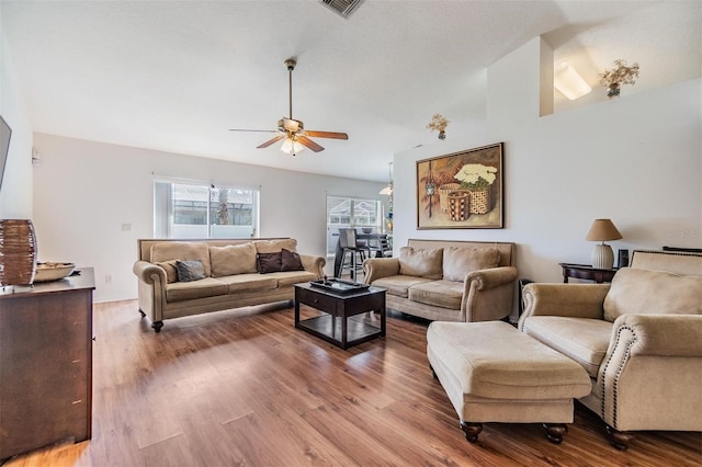 7046 Frascati Loop, Wesley Chapel, FL 33544 - living room featuring a ceiling fan, wood finished floors, and vaulted ceiling