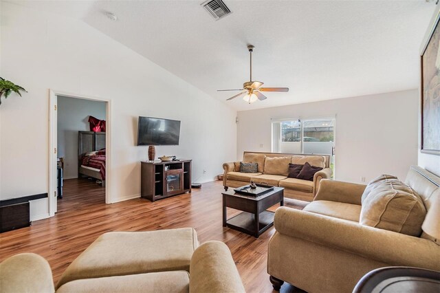 7046 Frascati Loop, Wesley Chapel, FL 33544 - living room with light wood finished floors, ceiling fan, and high vaulted ceiling