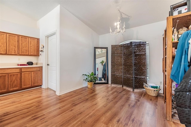 7046 Frascati Loop, Wesley Chapel, FL 33544 - unfurnished dining area featuring vaulted ceiling, a chandelier, and light wood-style floors