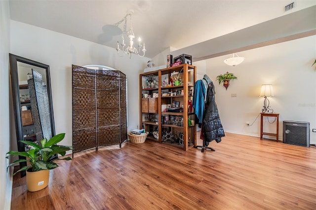 7046 Frascati Loop, Wesley Chapel, FL 33544 - dining area with wood finished floors, a chandelier, and vaulted ceiling