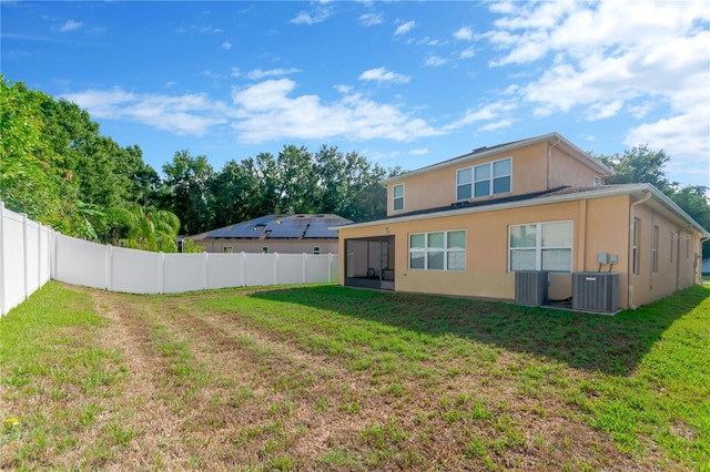 320 Roxbury Crossing Ct, Valrico, FL 33594 - back of property with stucco siding, a fenced backyard, and a sunroom