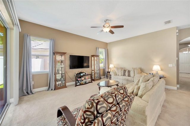 320 Roxbury Crossing Ct, Valrico, FL 33594 - carpeted living room with ceiling fan, plenty of natural light, and arched walkways