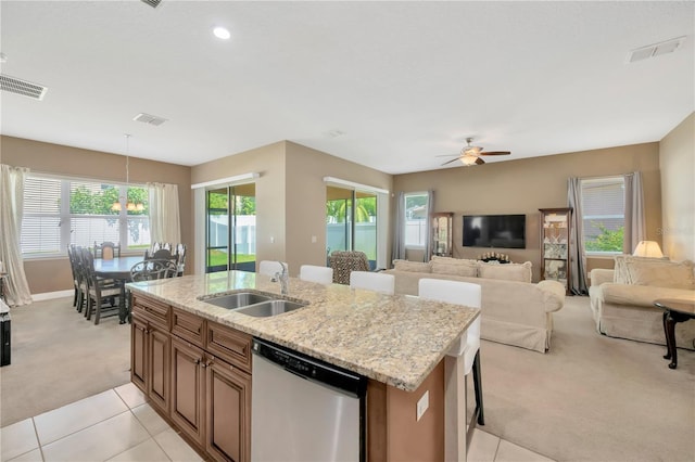320 Roxbury Crossing Ct, Valrico, FL 33594 - kitchen with stainless steel dishwasher, light colored carpet, a ceiling fan, an island with sink, and healthy amount of natural light