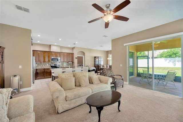 320 Roxbury Crossing Ct, Valrico, FL 33594 - living area featuring light colored carpet, ceiling fan, arched walkways, and recessed lighting