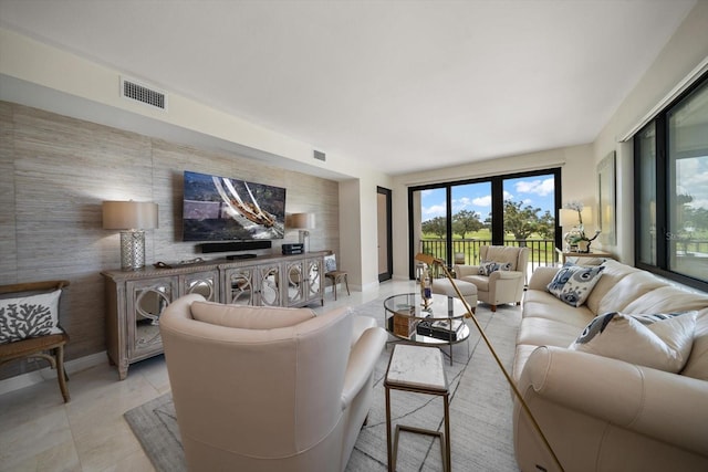 4 Belleview Blvd Unit 305, Belleair, FL 33756 - living area with an accent wall and plenty of natural light