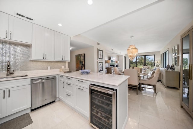 4 Belleview Blvd Unit 305, Belleair, FL 33756 - kitchen featuring stainless steel dishwasher, beverage cooler, a peninsula, open floor plan, and white cabinetry