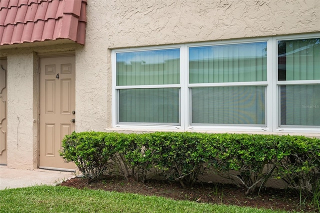 10033 64th Ave N Unit 4, Saint Petersburg, FL 33708 - doorway to property with stucco siding and a tiled roof