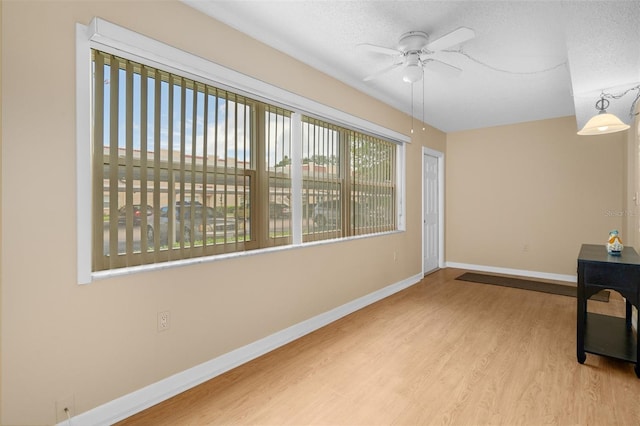 10033 64th Ave N Unit 4, Saint Petersburg, FL 33708 - unfurnished room featuring wood finished floors, ceiling fan, and a textured ceiling