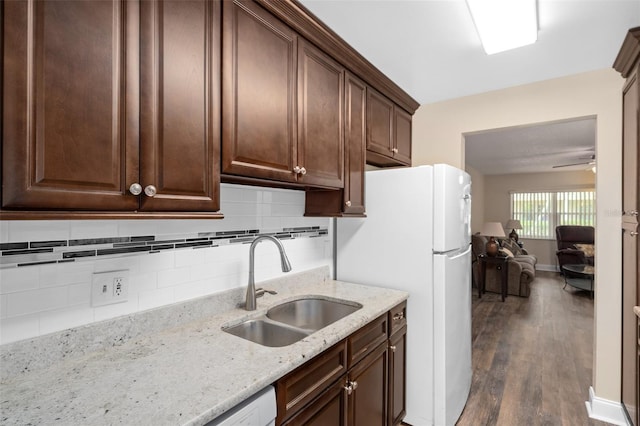 10033 64th Ave N Unit 4, Saint Petersburg, FL 33708 - kitchen with dark wood-style floors, freestanding refrigerator, backsplash, and light stone counters