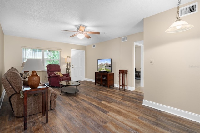10033 64th Ave N Unit 4, Saint Petersburg, FL 33708 - living area with dark wood finished floors, ceiling fan, and a textured ceiling