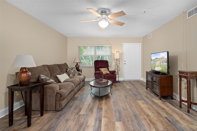 10033 64th Ave N Unit 4, Saint Petersburg, FL 33708 - living room with wood finished floors, ceiling fan, and a textured ceiling