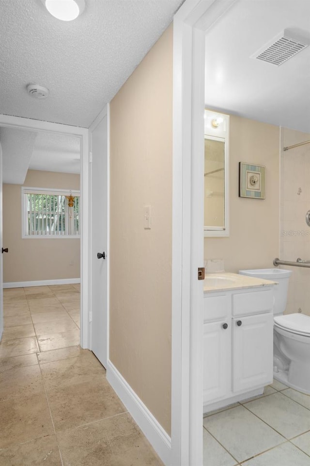 10033 64th Ave N Unit 4, Saint Petersburg, FL 33708 - bathroom with vanity, a textured ceiling, a shower, and tile patterned flooring